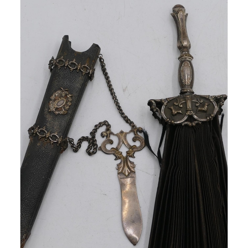 305 - A silver plated collapsible fan in form of a dagger, with leather sheath, embossed decoration, a set... 