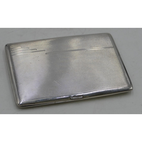 311 - A Birmingham silver cigarette case with engine turn decoration, hinged front, 11.5cm high, 4.7oz.