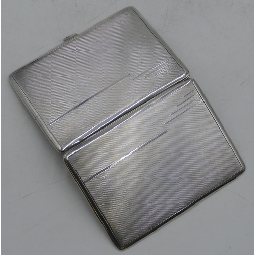 311 - A Birmingham silver cigarette case with engine turn decoration, hinged front, 11.5cm high, 4.7oz.