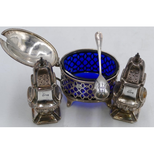 327 - An oval London silver mustard pot with hinged lid, enclosing blue glass liner and splayed feet, silv... 