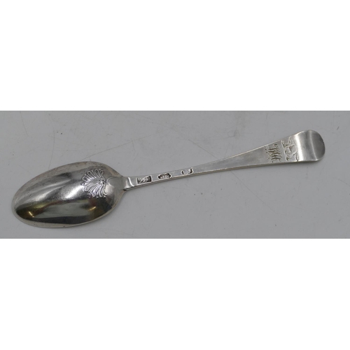 332 - An Irish Georgian dessert spoon with shell shaped back and engraved crest, 1.1oz