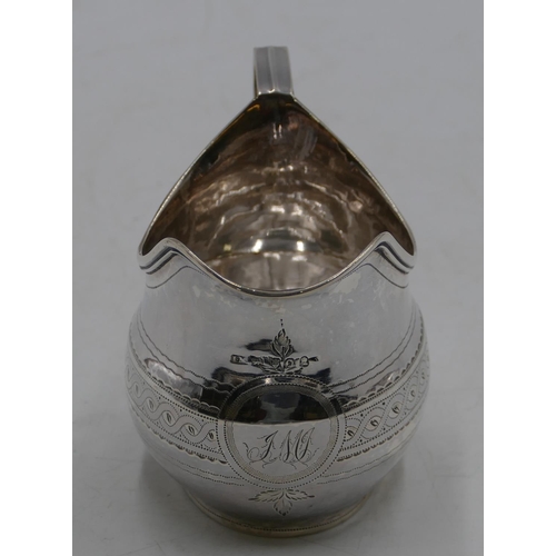 336 - A George III silver helmet shaped milk jug with part engraved scroll decoration, London 1809, makers... 