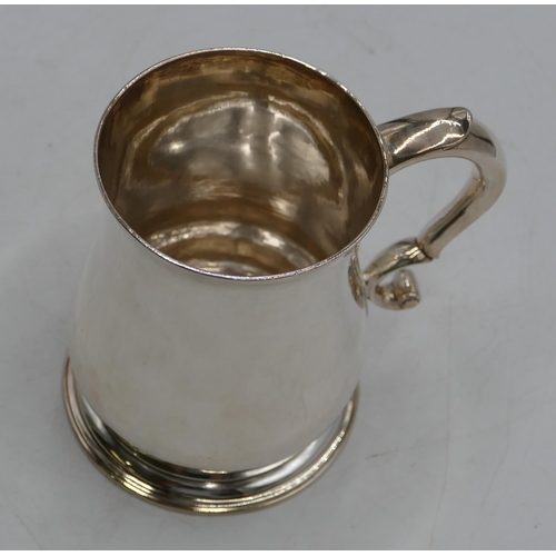 337 - A George II silver round bulbous shaped plain tankard with scroll handle on round sweeping foot, Lon... 