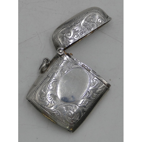 338 - A Birmingham silver vesta case with hinged lid and chased scroll decoration