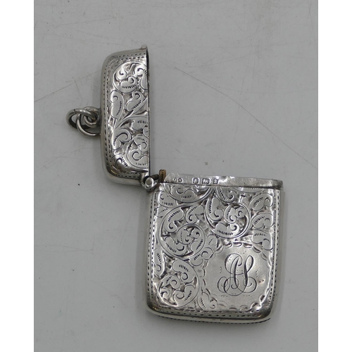 339 - A Birmingham silver vesta case with hinged lid, allover engraved scroll and leaf decoration (slight ... 