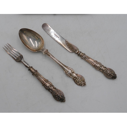 355 - A Victorian silver 3-piece christening set, 1 fork, knife and spoon with embossed scroll handles, Sh... 