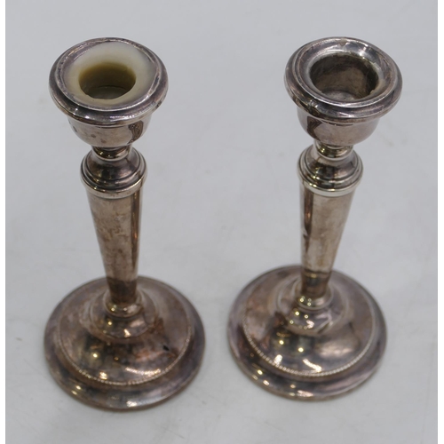 356 - A pair of Birmingham silver candlesticks on round turn stems with sweeping bases, 16cm high