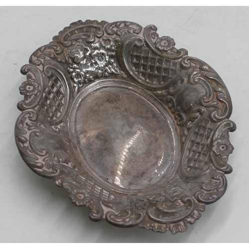 357 - A Birmingham silver oval scallop shaped sweet meat dish with allover embossed leaf and scroll decora... 