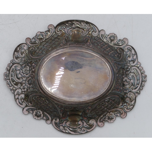 357 - A Birmingham silver oval scallop shaped sweet meat dish with allover embossed leaf and scroll decora... 