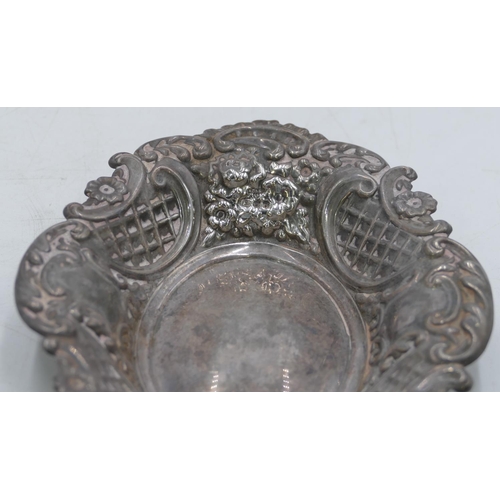 357 - A Birmingham silver oval scallop shaped sweet meat dish with allover embossed leaf and scroll decora... 