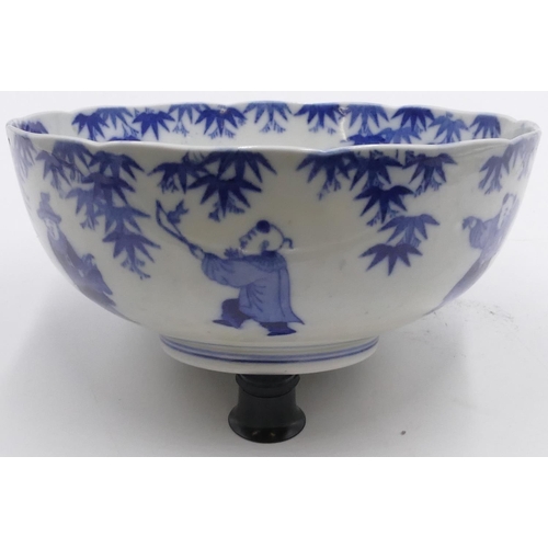 36 - An Oriental blue and white round bowl with allover figure decoration, 25cm diameter.
