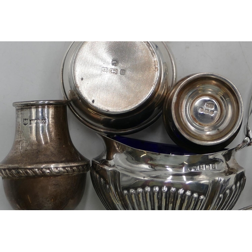 367 - An oval Birmingham silver mustard pot with hinged lid and part embossed reeded decoration, enclosing... 