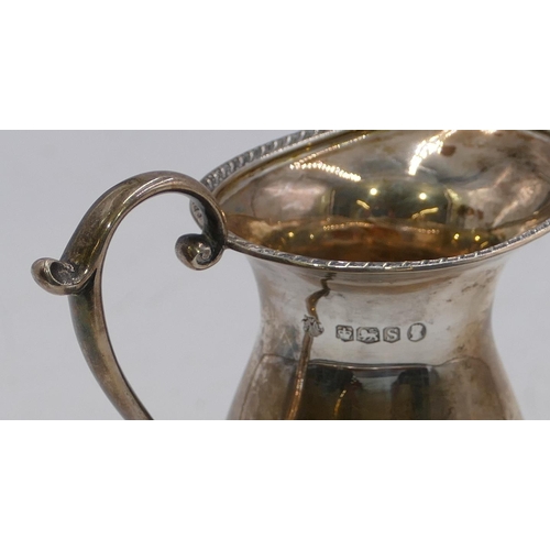 370 - A Sheffield silver round bulbous shaped milk jug with scroll handle on sweeping foot, maker William ... 