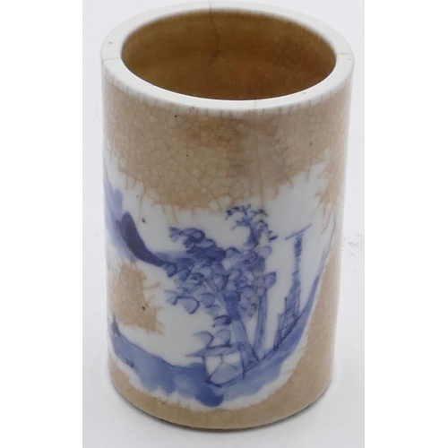 39 - An Oriental cylindrical brush pot on white and blue ground with landscape decoration, seal mark to b... 
