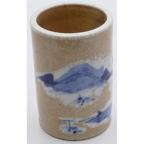39 - An Oriental cylindrical brush pot on white and blue ground with landscape decoration, seal mark to b... 