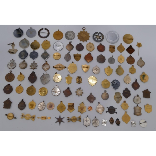 407 - A large quantity of various brass and gilt metal archery medals.