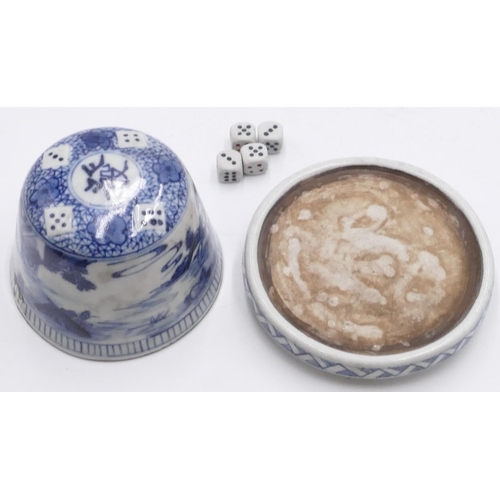 41 - An Oriental China dice pot with cover on blue and white ground on stand, landscape and dice decorati... 