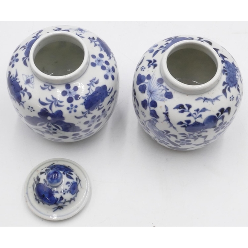 42 - A pair of 19th Century Oriental round bulbous thin necked vases (1 with cover) on blue and white gro... 