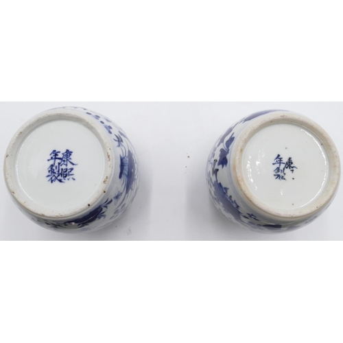 42 - A pair of 19th Century Oriental round bulbous thin necked vases (1 with cover) on blue and white gro... 