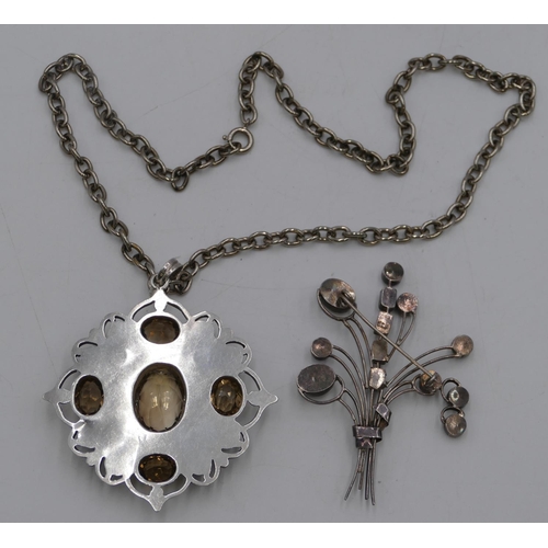 422 - A large silver pendant set with smoky quartz, with chain and another silver floral spray brooch set ... 