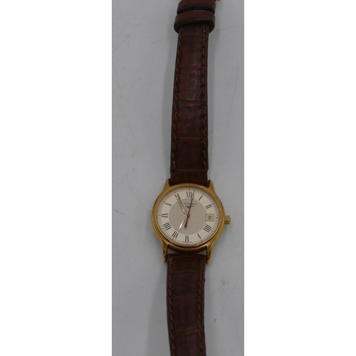 447 - A ladies Longines circular wristwatch with seconds hand and calendar and leather strap bracelet.