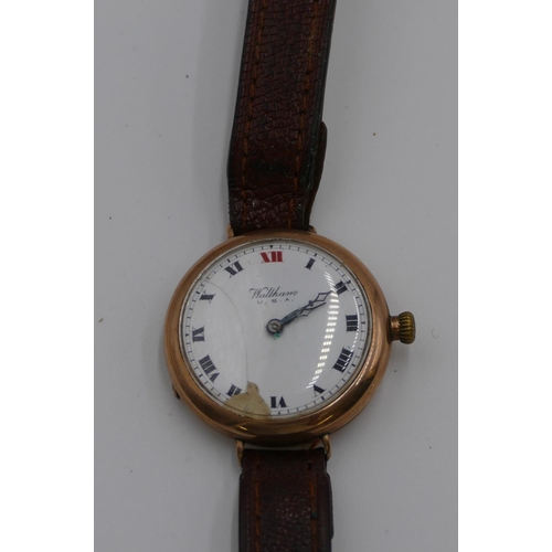 448 - A 9ct gold Waltham circular wristwatch with white enamel dial (dial a/f), leather strap (not working... 