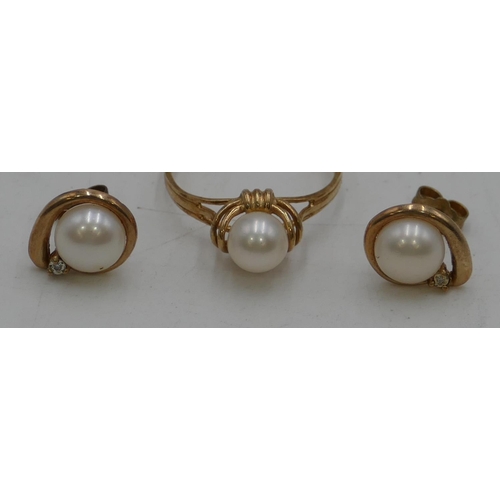 453 - A 9ct gold ladies ring set with cultured pearls, size R/S and a pair of 9ct gold earrings mounted wi... 