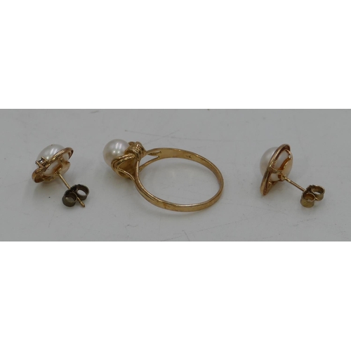 453 - A 9ct gold ladies ring set with cultured pearls, size R/S and a pair of 9ct gold earrings mounted wi... 