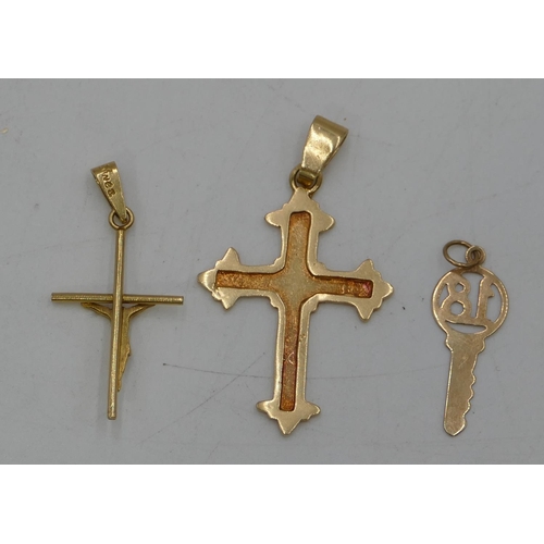 455 - An 18ct gold cross pendant, a high ct gold cross pendant and a gold charm (18 mounted in a key), 6 g... 