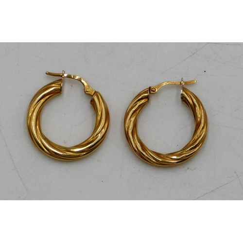 457 - A pair of small 18ct gold hoop earrings, 3.9 grams.