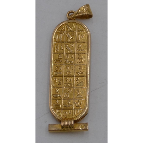 463 - An Egyptian 9ct gold pendant with allover raised animal and inscription decoration, 4.8cm high, 9.5 ... 