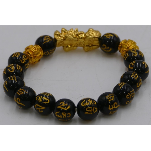 469 - An Oriental black bead bracelet.