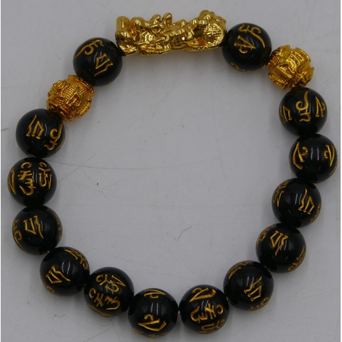 469 - An Oriental black bead bracelet.