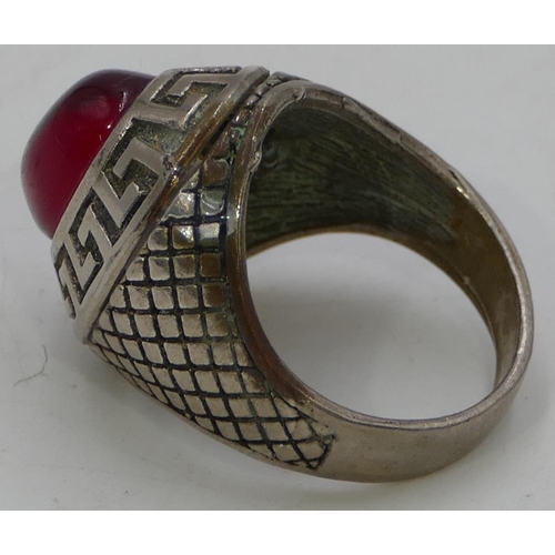 470 - A gentleman's oval ring set with red stone, size T/U.