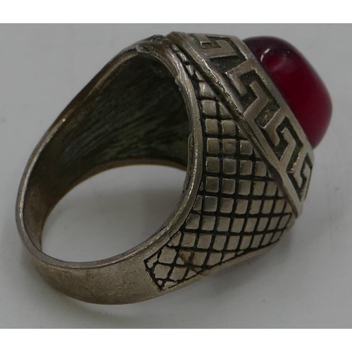 470 - A gentleman's oval ring set with red stone, size T/U.