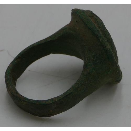 475 - A Roman style metal ring with oval top, raised figurehead of a gentleman, size O/P.