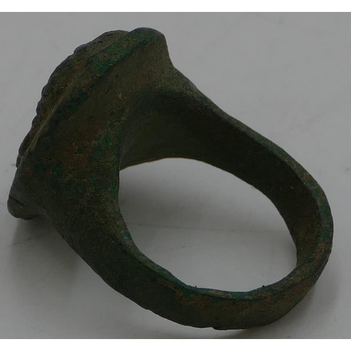 475 - A Roman style metal ring with oval top, raised figurehead of a gentleman, size O/P.