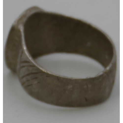 476 - A silvered Roman style signet ring with engraved inscription to top, size O.