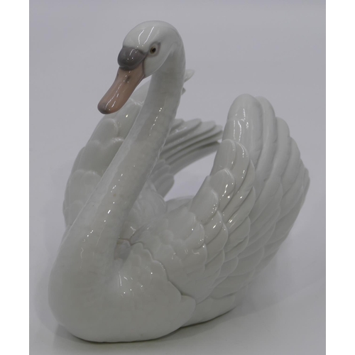 48 - A Lladro figure of a swan with raised wings, 18cm high.