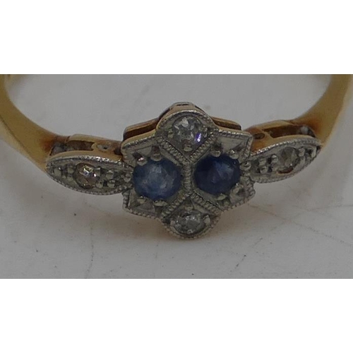 484 - An 18ct gold ladies ring set with 2 small sapphires, interspersed with small diamond chips, Size L