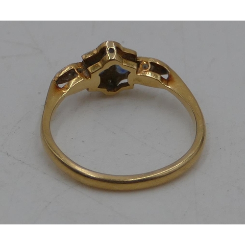 484 - An 18ct gold ladies ring set with 2 small sapphires, interspersed with small diamond chips, Size L