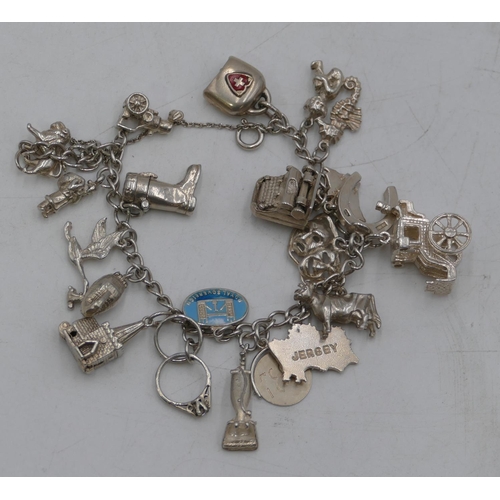 497 - A silver bracelet mounted with 21 charms, 61.8g