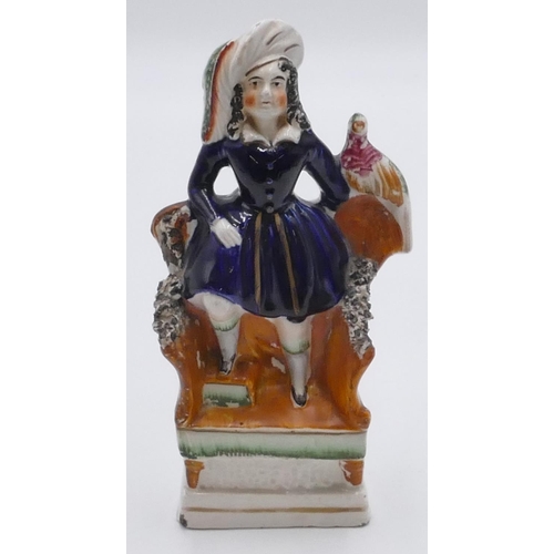 5 - A 19th Century Staffordshire figure of a young girl standing on a chair with bird motif, 20cm high.