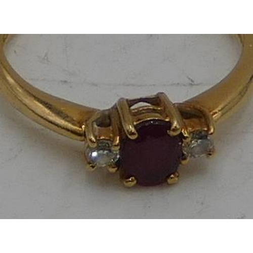 507 - An 18ct gold ladies ring set with centre ruby, flanked by 2 small diamonds, size M/N, 3g