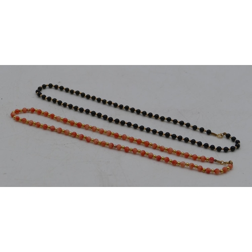 519 - A 9ct gold bead necklace interspersed with coral, and a  similar 9ct gold bead necklace interspersed... 