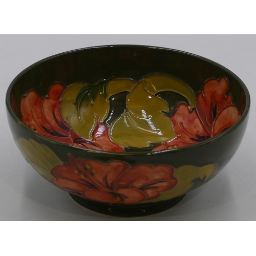 52 - A Moorcroft round bowl on green ground with coloured floral and leaf decoration, 16cm diameter.
