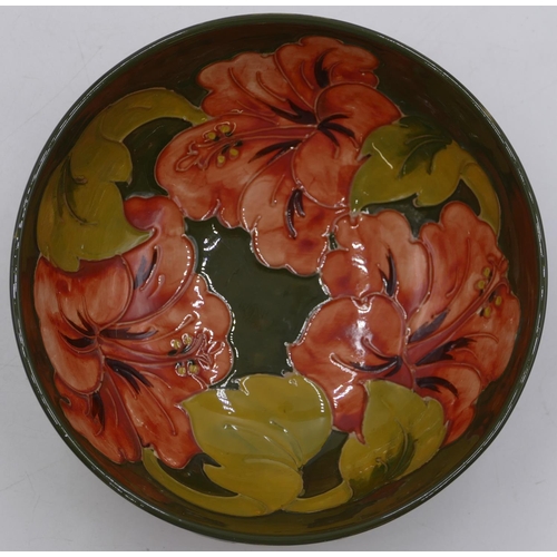52 - A Moorcroft round bowl on green ground with coloured floral and leaf decoration, 16cm diameter.