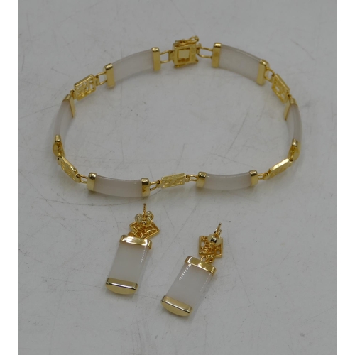 526 - A white hardstone Oriental panel bracelet and a pair of similar drop earrings.