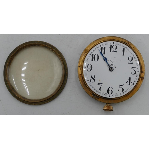 527 - A Brevet circular brass timepiece no. 33236 with white enamel dial, Arabic numerals, 7.5cm wide.