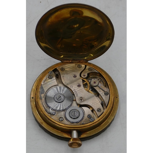 527 - A Brevet circular brass timepiece no. 33236 with white enamel dial, Arabic numerals, 7.5cm wide.